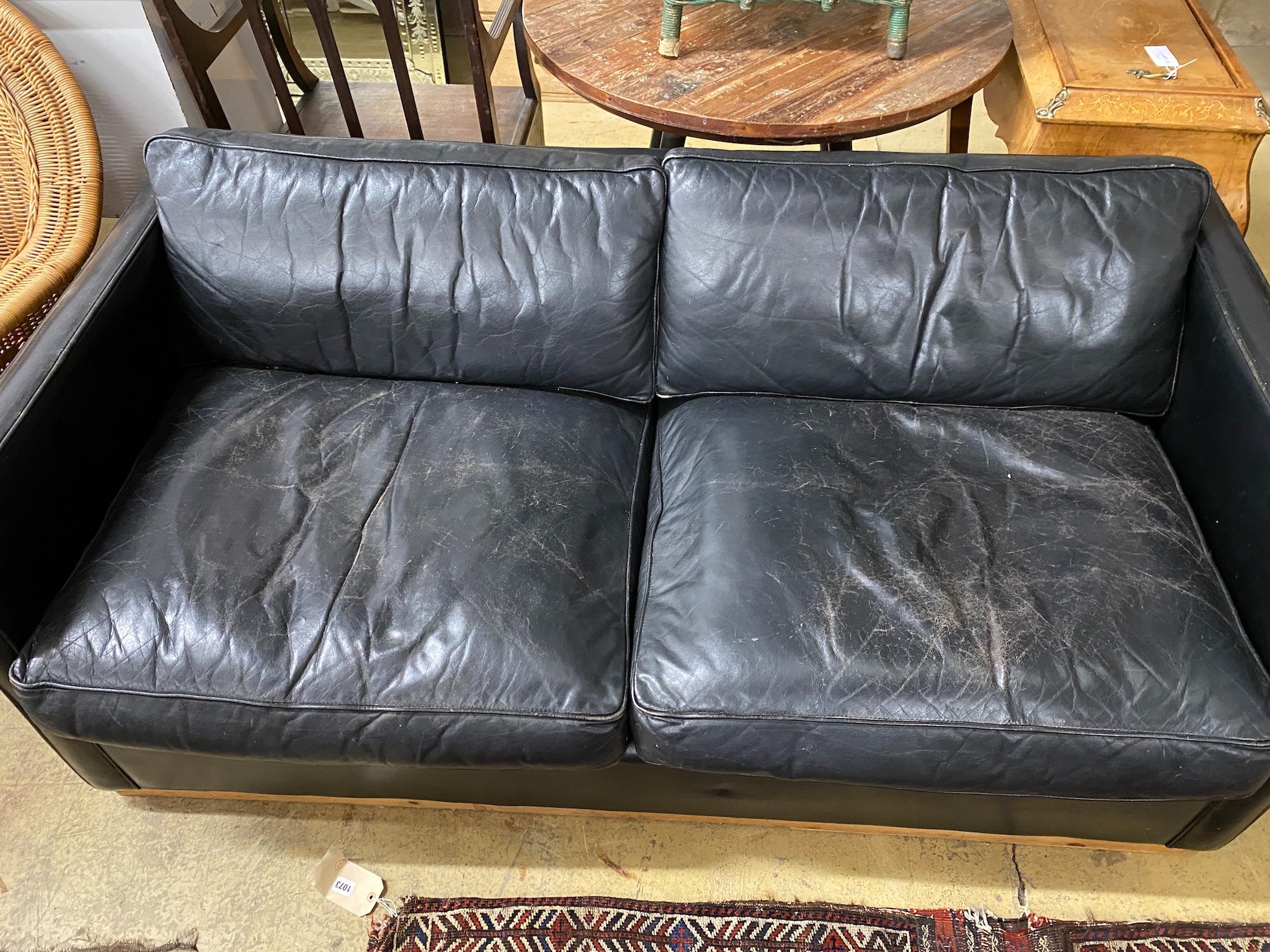A black leather upholstered two seater sofa bed, length 172cm